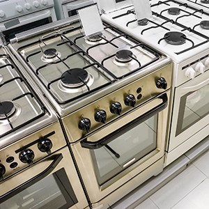 rows of gas stoves selling in home appliance store