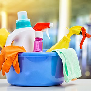 cleaning supplies in a large blue bucket