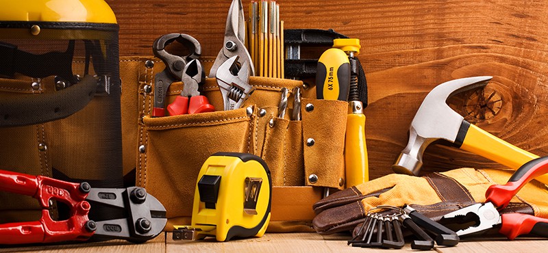 set of working tools on wooden boards