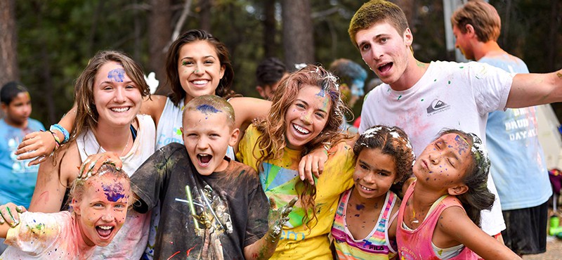 kids at camp kesem camp smiling covered in paint