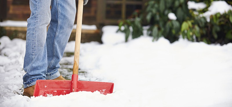 Man shoveling show in winter