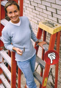 lady standing on ladder leaned against a wall