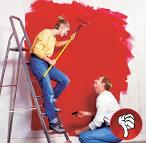 two people painting a wall, lady on ladder incorrectly