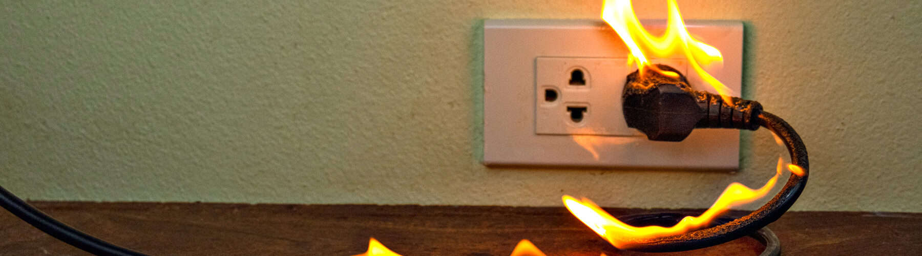 electric wall plug on fire
