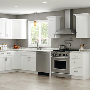 white kitchen cabinets with stainless steel appliances and a laminate countertop