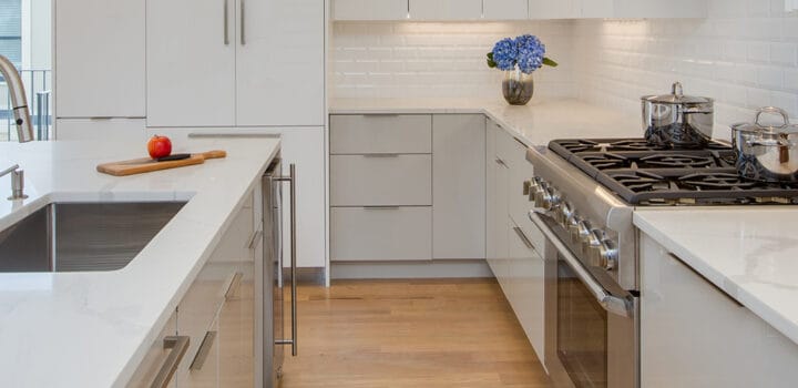 side view of a contemporary white and grey kitchen design with quartz countertops in East Boston, MA