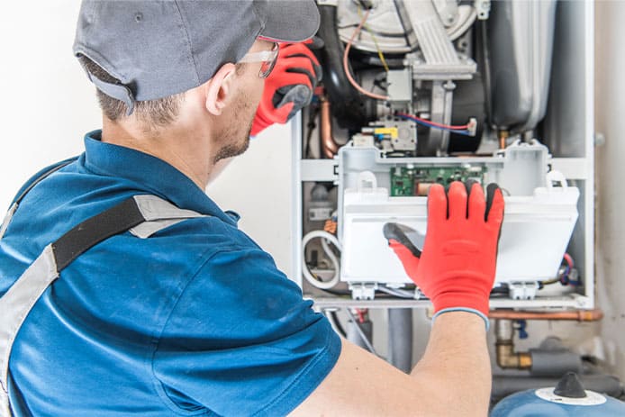 an HVAC technician performing an annual furnace inspection